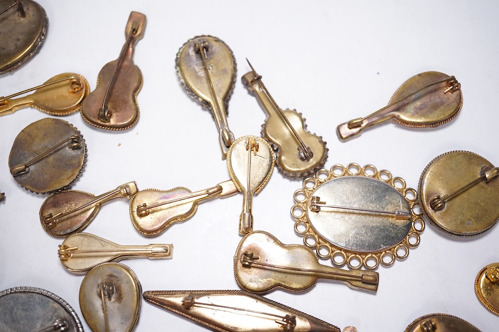 A collection of thirty-one micro-mosaic brooches, including fourteen mixed guitar and banjo shaped brooches, six large oval brooches and seven smaller brooches, three long brooches and a star shaped brooch. Condition - g